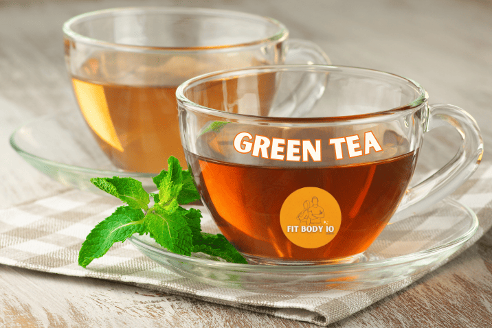 A cup of freshly brewed green tea, its delicate golden-green hue illuminated by soft natural light, with a green tea leaf gracefully unfurling in the cup.